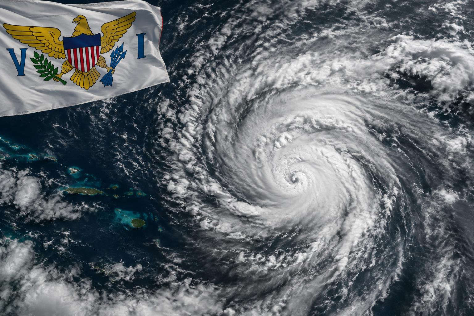 Satellite view of a subtropical storm system swirling over the Atlantic Ocean with the U.S. Virgin Islands flag in the corner, dramatic cloud formations visible from above, stormy grey and white tones